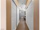 Hallway featuring white closet doors on either side and beige walls at 2616 Faiss Dr, Las Vegas, NV 89134