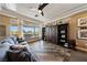 Stylish living room with large windows, custom built-in shelving, and plush seating to enjoy the backyard view at 2616 Faiss Dr, Las Vegas, NV 89134