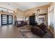 Open-concept living room with stylish decor, dark-wood furniture, and a view of the front entrance at 2616 Faiss Dr, Las Vegas, NV 89134