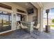Stylish outdoor bar area with seating, a TV, and a refrigerator, perfect for relaxing and entertaining outdoors at 2616 Faiss Dr, Las Vegas, NV 89134