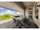 Inviting covered patio dining area with a large table, chairs, and an outdoor kitchen in a backyard with a view at 2616 Faiss Dr, Las Vegas, NV 89134