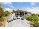 Serene backyard featuring comfortable outdoor seating areas, a covered patio, and lush landscaping at 2616 Faiss Dr, Las Vegas, NV 89134