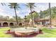 Elegant water fountain with lush landscaping and palm trees, enhancing the community's serene atmosphere at 2616 Faiss Dr, Las Vegas, NV 89134