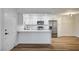 Modern kitchen with stainless steel appliances, white cabinets, and breakfast bar seating at 2725 S Nellis Blvd # 2036, Las Vegas, NV 89121