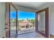 Balcony view showing community pool, nearby desert landscaping, and townhome rooftops at 2766 Red Vista Ct, Henderson, NV 89074