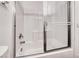 Bathroom featuring tiled tub and shower with glass door at 2766 Red Vista Ct, Henderson, NV 89074