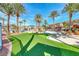 Outdoor area with putting green, lounge seating, tables, and palm trees with inviting atmosphere at 2766 Red Vista Ct, Henderson, NV 89074