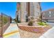 Condominium exterior showing manicured landscaping, including retaining wall, colorful flowers, and fenced yard at 2766 Red Vista Ct, Henderson, NV 89074