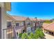 Exterior view of the townhome showcasing a red tile roof and desert landscaping at 2766 Red Vista Ct, Henderson, NV 89074
