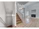 Bright living room with a fireplace, tile floors, staircase, and high ceilings at 2766 Red Vista Ct, Henderson, NV 89074