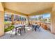 Covered patio featuring seating, tables, and community pool views, perfect for relaxation at 2766 Red Vista Ct, Henderson, NV 89074