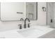 Bathroom with a sleek mirror, black fixtures, and a quartz countertop at 2854 La Canada St, Las Vegas, NV 89169