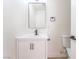 Bathroom featuring a modern vanity with black hardware and framed mirror, with a toilet nearby at 2854 La Canada St, Las Vegas, NV 89169