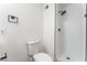 Bathroom with a white toilet, modern black hardware and fixtures, and a walk-in shower with white subway tile at 2854 La Canada St, Las Vegas, NV 89169