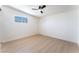 Spacious room with fan features new wood flooring, base molding, and a sunny window at 2854 La Canada St, Las Vegas, NV 89169