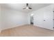 Bright bedroom features a ceiling fan, light wood floor and trim, and access to a private bathroom at 2854 La Canada St, Las Vegas, NV 89169
