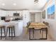 Modern kitchen boasts white cabinets, stone countertops, stainless appliances, and adjacent dining area at 2854 La Canada St, Las Vegas, NV 89169
