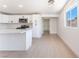 Modern kitchen features white cabinets, stone countertops, stainless steel appliances; bright and airy at 2854 La Canada St, Las Vegas, NV 89169