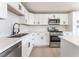 Bright kitchen featuring stainless steel appliances, white cabinets, and quartz countertops at 2854 La Canada St, Las Vegas, NV 89169