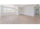 Bright, empty living room features large windows, white walls, and light wood floors at 2854 La Canada St, Las Vegas, NV 89169