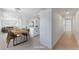 Open floorplan with dining and living area leads to a bright hallway; perfect for entertaining at 2854 La Canada St, Las Vegas, NV 89169