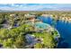 Beautiful aerial view of a community with a lagoon, sandy beach, clubhouse, pool and palm trees and lush landscaping at 3125 N Buffalo Dr # 1133, Las Vegas, NV 89128