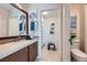 Bathroom featuring a large mirror, vanity with drawers, and an adjacent closet at 3125 N Buffalo Dr # 1133, Las Vegas, NV 89128