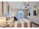 Inviting bedroom with neutral tones, a large window, ceiling fan, and unique wall art at 3125 N Buffalo Dr # 1133, Las Vegas, NV 89128