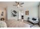 Comfortable bedroom features a cozy chair, wood floors, and view into the hallway at 3125 N Buffalo Dr # 1133, Las Vegas, NV 89128