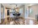Inviting dining area showcases wood floors, modern lighting, and a view of the kitchen and front entry at 3125 N Buffalo Dr # 1133, Las Vegas, NV 89128