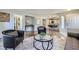 Open-concept living area boasts wood floors and seamless transition into dining area with barstool seating at 3125 N Buffalo Dr # 1133, Las Vegas, NV 89128