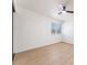 Bright, empty bedroom with light-colored, wood-look floors, white walls, and a window at 3320 Osage Ave, Las Vegas, NV 89101