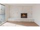 Living room featuring a stone fireplace with a black insert, complemented by the hardwood flooring and natural light at 3320 Osage Ave, Las Vegas, NV 89101