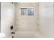 New tiled shower featuring a rain shower faucet, window, and black fixtures at 3320 Osage Ave, Las Vegas, NV 89101