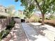 Backyard featuring concrete pavers, a mature tree, and privacy walls at 39 Belle La Blanc Ave, Las Vegas, NV 89123