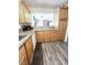 Kitchen with granite countertops, wooden cabinets, and matching flooring at 39 Belle La Blanc Ave, Las Vegas, NV 89123