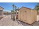 A view of the backyard featuring a hot tub and shed in the gravel yard at 4010 Hemphill St, North Las Vegas, NV 89032