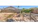 Backyard with a block wall, stone walkway, and some garden vegetation at 4010 Hemphill St, North Las Vegas, NV 89032