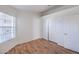 Bedroom with laminate floors, window with blinds, and closet with sliding doors at 4010 Hemphill St, North Las Vegas, NV 89032
