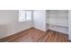 Bright bedroom featuring wood floors, natural light from a window, and a built-in storage niche at 4010 Hemphill St, North Las Vegas, NV 89032