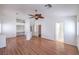 Bright bedroom with hardwood floors, ceiling fan, and closet space for storage with a built-in desk at 4010 Hemphill St, North Las Vegas, NV 89032