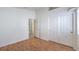 Bedroom with wood laminate floors, white trim, closet and entry doors, and a bright window at 4010 Hemphill St, North Las Vegas, NV 89032