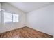Spacious bedroom with laminate floors and a large window allowing plenty of natural light at 4010 Hemphill St, North Las Vegas, NV 89032