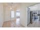 Bright entryway leading into the living spaces with views of the kitchen and wood-look flooring at 4010 Hemphill St, North Las Vegas, NV 89032