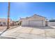 Single-story home featuring an attached two-car garage, desert landscaping, and a red-tiled roof at 4010 Hemphill St, North Las Vegas, NV 89032