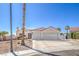Single-story home featuring an attached two-car garage, desert landscaping, and a red-tiled roof at 4010 Hemphill St, North Las Vegas, NV 89032
