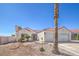 Single-story home featuring an attached two-car garage, desert landscaping, and a red-tiled roof at 4010 Hemphill St, North Las Vegas, NV 89032