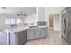 Open-concept kitchen with stainless steel appliances, countertop seating, and a view into the living area at 4010 Hemphill St, North Las Vegas, NV 89032
