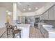 Bright kitchen featuring stainless appliances, countertops, grey cabinets, and a tiled backsplash at 4010 Hemphill St, North Las Vegas, NV 89032