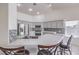 Modern kitchen features stainless appliances, granite countertops, and backsplash, with a breakfast bar and tile floors at 4010 Hemphill St, North Las Vegas, NV 89032